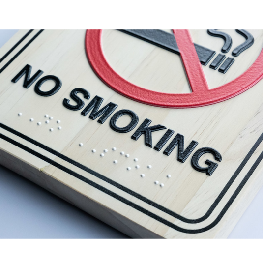 No Smoking sign printed with braille text on a white background via Artisjet 5000 printer